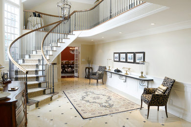 Design ideas for a large traditional foyer in New York with white walls and marble flooring.