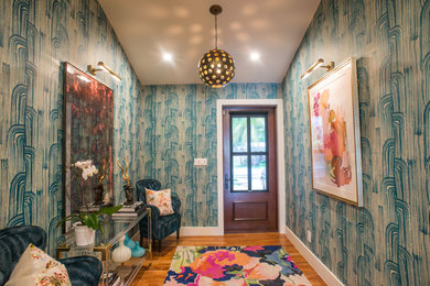 Inspiration for a mid-sized eclectic medium tone wood floor entryway remodel in Miami with multicolored walls and a dark wood front door