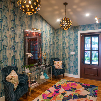 Example of a mid-sized eclectic medium tone wood floor entryway design in Miami with multicolored walls and a dark wood front door