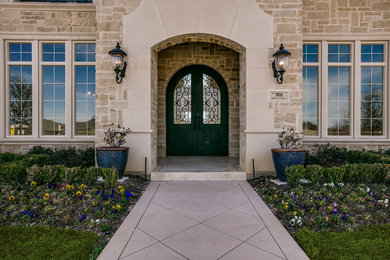 Inspiration for a timeless entryway remodel in Dallas with a black front door
