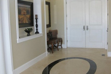 Entryway - mid-sized traditional ceramic tile entryway idea in Other with beige walls and a white front door