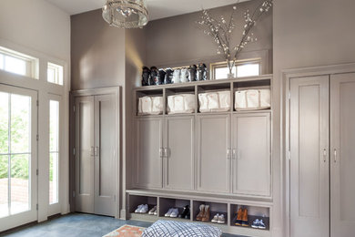 Example of a classic gray floor mudroom design in New York with gray walls