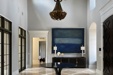 Entryway - large transitional travertine floor and beige floor entryway idea in Orlando with gray walls and a dark wood front door