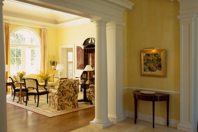 Example of a large classic marble floor foyer design in Miami with yellow walls