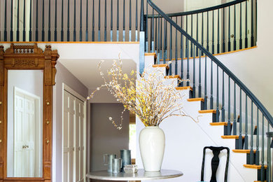 Inspiration for a large transitional medium tone wood floor foyer remodel in New York with white walls