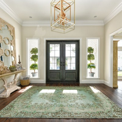 Inspiration for a large transitional dark wood floor and brown floor entryway remodel in Tampa with beige walls and a gray front door