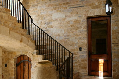 Large tuscan concrete floor entryway photo in San Francisco with beige walls and a dark wood front door