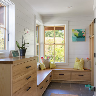 Example of a mid-sized transitional porcelain tile and gray floor mudroom design in Portland Maine with white walls and a medium wood front door