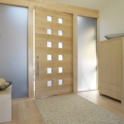 Entryway - mid-sized contemporary light wood floor entryway idea in San Francisco with a light wood front door and white walls