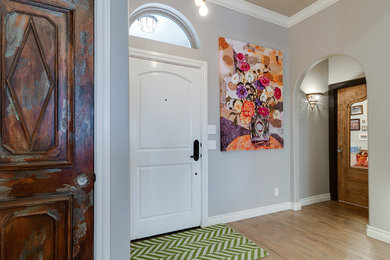Example of a mid-sized transitional light wood floor and beige floor entryway design in Oklahoma City with gray walls and a white front door