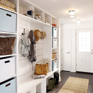 Example of a transitional dark wood floor and brown floor single front door design in Cleveland with white walls and a white front door