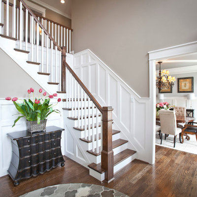 Example of a mid-sized transitional medium tone wood floor foyer design in Cincinnati with gray walls