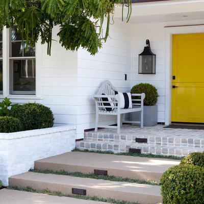 Elegant entryway photo in Orange County with a yellow front door