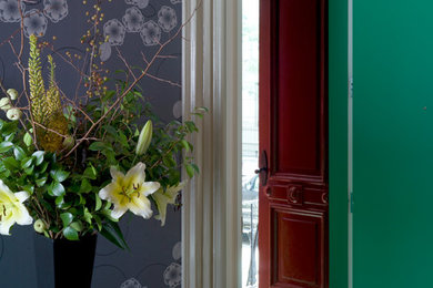 Inspiration for a mid-sized entryway remodel in New York with green walls and a red front door