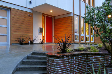 Photo of a contemporary front door in Seattle with a single front door and a red front door.