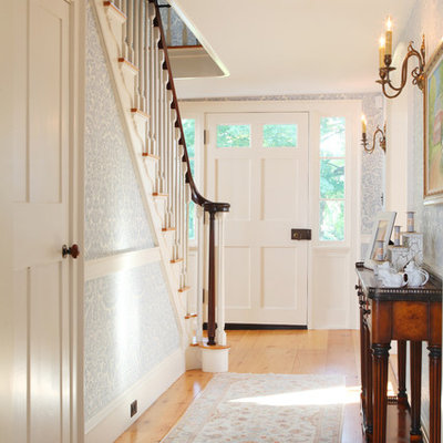 Entryway - mid-sized traditional medium tone wood floor and beige floor entryway idea in Boston with a white front door and multicolored walls