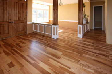 Example of a mid-sized transitional medium tone wood floor entryway design in Boise with beige walls and a medium wood front door