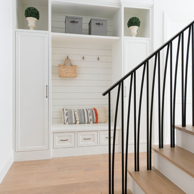 Inspiration for a mediterranean light wood floor and beige floor mudroom remodel in Dallas with white walls