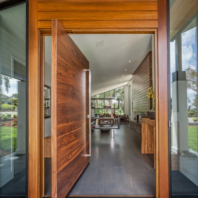 Pivot front door - contemporary dark wood floor pivot front door idea in San Francisco with white walls and a dark wood front door