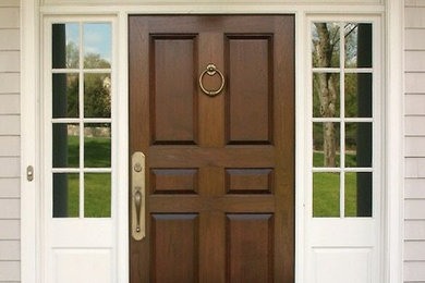 This is an example of a traditional entrance in Philadelphia with beige walls, a single front door and a light wood front door.