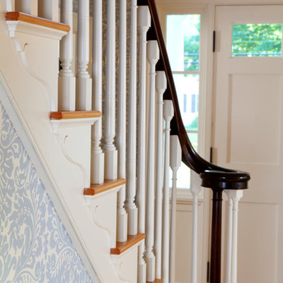 Inspiration for a mid-sized cottage medium tone wood floor entryway remodel in Boston with multicolored walls and a white front door