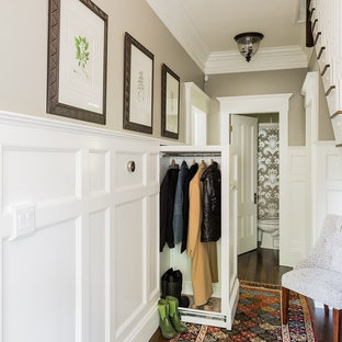 Example of a classic mudroom design in Boston with beige walls