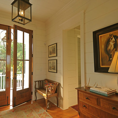 Inspiration for a timeless double front door remodel in Charleston with beige walls and a glass front door