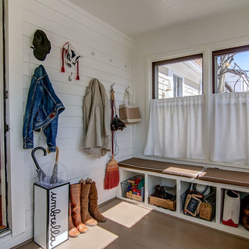 Hooks and built-in benches with cubbies turn a small porch into a mud room.