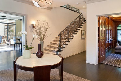 Large trendy dark wood floor foyer photo in New York with white walls