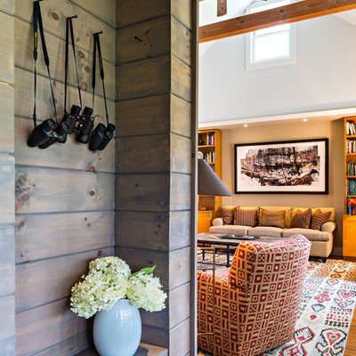 Example of a small cottage concrete floor foyer design in New York with brown walls