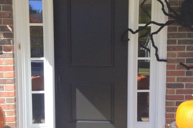 Entryway - traditional entryway idea in St Louis with a black front door