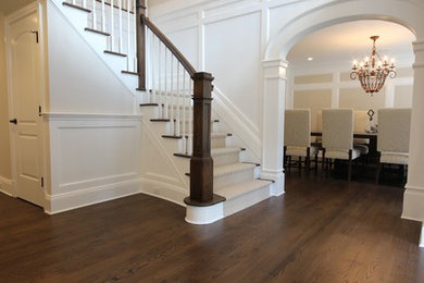 Entryway - large transitional dark wood floor entryway idea in New York with a dark wood front door and white walls