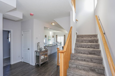 Entryway - modern entryway idea in Toronto with white walls and a white front door