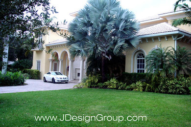 Example of a large tuscan marble floor and beige floor entryway design in Miami with yellow walls and a white front door