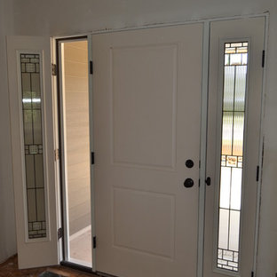 Idee per una porta d'ingresso american style di medie dimensioni con pavimento in compensato e una porta bianca