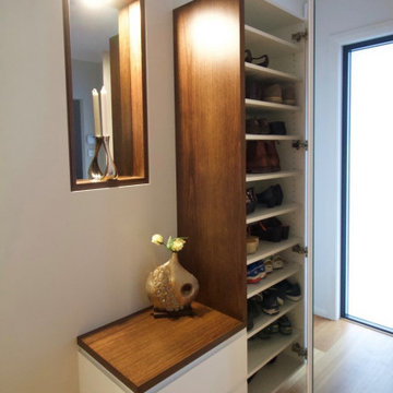 'L' Shaped media unit, and shoe cupboard at entry