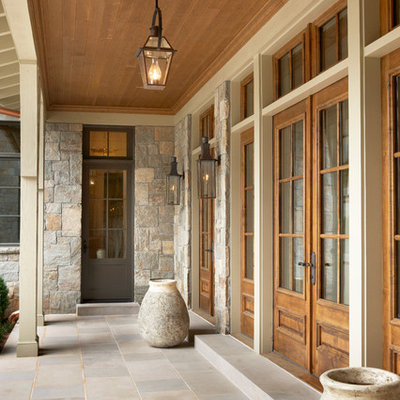 Single front door - huge traditional single front door idea in Other with a medium wood front door
