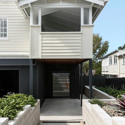 Example of a trendy beige floor entryway design in Brisbane with a glass front door