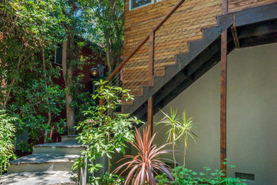 Example of a 1960s front door design in Los Angeles with a medium wood front door