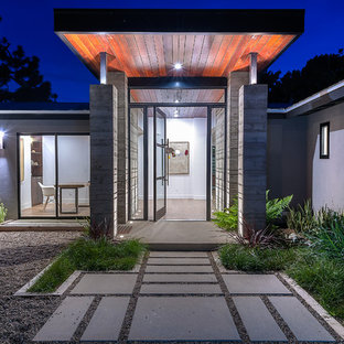 Mid-sized trendy concrete floor entryway photo in San Diego with a glass front door and gray walls