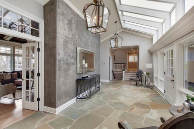 Example of a large transitional multicolored floor entryway design in Orange County with gray walls and a white front door