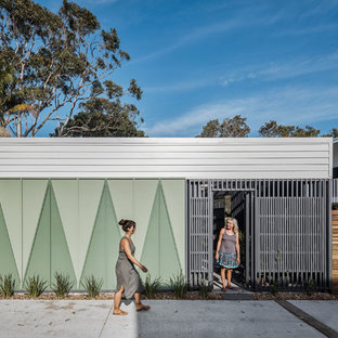 Inspiration for a beach style front door in Gold Coast - Tweed with green walls, concrete floors, a single front door, a gray front door and grey floor.