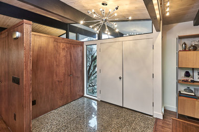 Mid-sized mid-century modern granite floor and multicolored floor entryway photo in San Francisco with white walls and a white front door