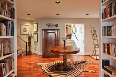 Example of a mid-sized classic medium tone wood floor and beige floor foyer design in Other with beige walls