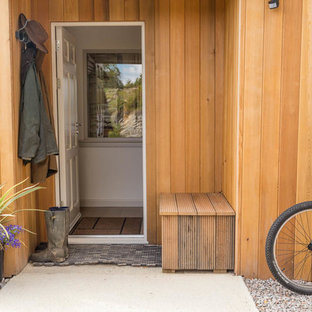 Contemporary front door in Other with brown walls, concrete flooring, a single front door, a white front door and grey floors.