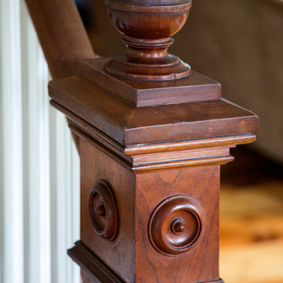 Small cottage foyer photo in Boston with a medium wood front door and black walls