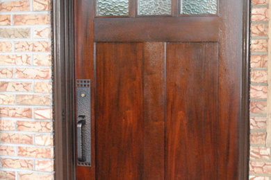 Inspiration for a mid-sized craftsman entryway remodel in Other with a dark wood front door