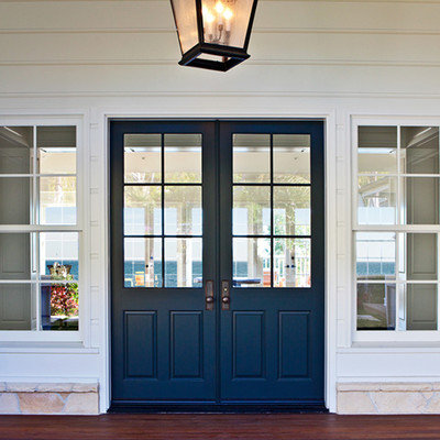 Inspiration for a mid-sized timeless dark wood floor entryway remodel in Los Angeles with white walls and a blue front door