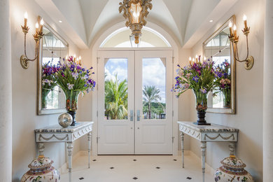 Photo of a traditional foyer in Tampa with grey walls, limestone flooring, a double front door and a white front door.