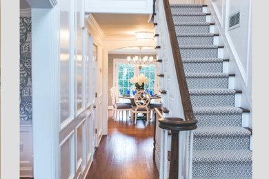 Inspiration for a mid-sized transitional medium tone wood floor and brown floor entry hall remodel in New York with white walls